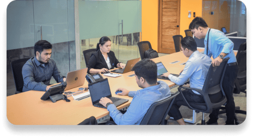 A diverse group of professionals collaborating on laptops in a modern TRT office environment.