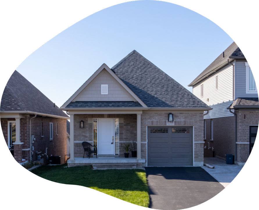 A house featuring a garage and a spacious driveway, showcasing a welcoming residential environment.