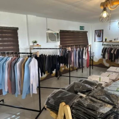 A vibrant clothing store featuring numerous racks of stylish clothes, part of TRT's corporate boutique initiative.